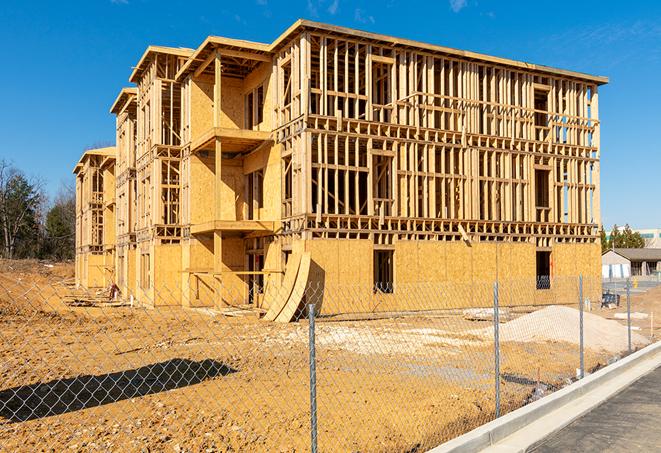 a close-up of temporary chain link fences enclosing a job site, signaling progress in the project's development in Hempstead